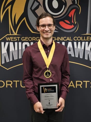 Matthieu Pilon holding award